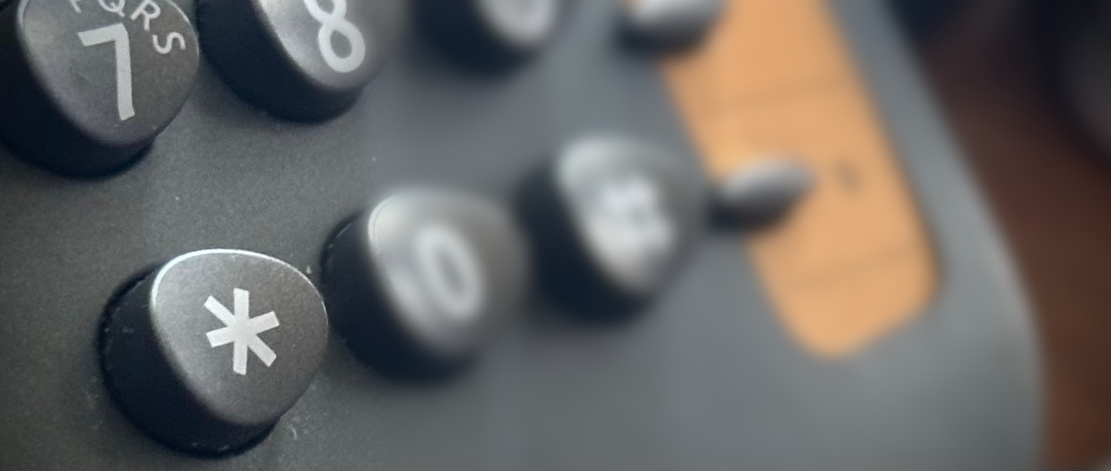 Closeup of a telephone keypad, highlighting the asterisk key